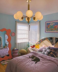 a cat laying on top of a bed in a bedroom