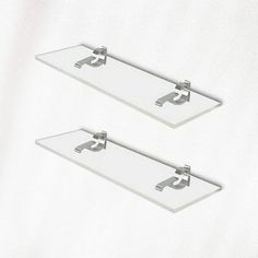 two glass shelves with metal brackets on them