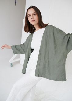 "DESCRIPTION If you want to build a comfortable and timeless wardrobe for all seasons, the Juta jacket is one of the pieces you may like to add to your closet. The oversized silhouette, kimono type sleeves, and a plain neckline help you create looks suitable for different settings and occasions. SIZING & FIT This garment is oversized. If you want to wear this piece as close-fitting, select a smaller size than you usually wear. Before placing an order, check the approximate measurements of th Outer Linen, Minimal Clothes, Green Kimono, Linen Kimono, Kimono Outfit, Tøp Aesthetic, Linen Coat, Cocoon Coat, Linen Jackets