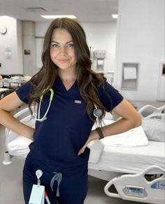 a woman standing in a hospital room with her hands on her hips