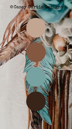 a blue and brown dream catcher with feathers