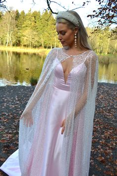 Sparkling semi-sheer sequin long wedding cape cover-up for bride, mother of the bride, or any formal look. THE 'IRIS' CAPE: This 'Iris' cape is beautifully simple and yet adds a touch of sparkle to your look, bringing heightened glamour. The semi-sheer nature also allows the shape of your dress or look underneath to shine through. This is an ideal cover-up for venues in which your shoulders must be covered (ie. Church or other religious buildings) or for those who would like to change up their w Formal Dress Cape, Sparkling Evening Gown For Wedding, Sequin Mother Of The Bride Evening Dress, Evening Sequined Mother Of The Bride Dress, Wedding Evening Dress With Cape, Glamorous Cape Sleeves Evening Dress For Wedding, Glamorous Wedding Evening Dress With Cape Sleeves, Glamorous Evening Dress For Mother Of The Bride, Wedding Gown With Sequins And Cape Sleeves