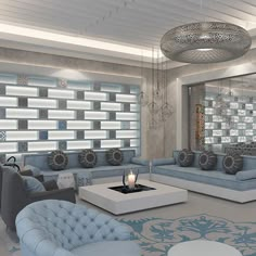 a living room filled with blue couches next to a white coffee table and chandelier