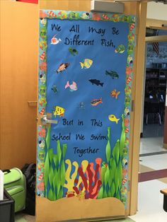 a door decorated with an ocean theme and saying, we all may be different fish but in this school we swim together