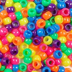 multicolored plastic beads are scattered on a white surface