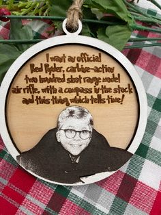 a wooden ornament with an image of a man on it