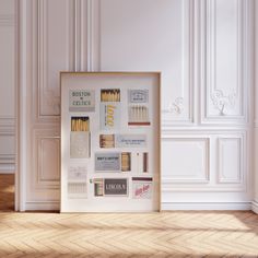 an empty room with white walls and wood flooring is shown in front of a framed poster