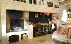 a kitchen with an oven, stove and chairs in it