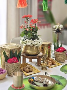 a table topped with lots of different types of food and flowers on top of it