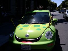 a green car with polka dots painted on it