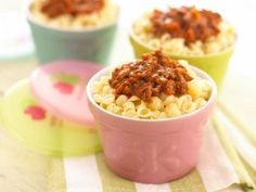 two cups filled with macaroni and cheese covered in chili