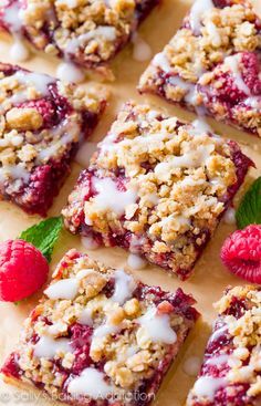 raspberry crumble bars with white icing and fresh raspberries on top