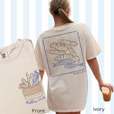 NEW Front Design (Latest Hand-drawn Illustration 🥖🐟 Five Loaves and Two Fish - Matthew 14:20🥖🐟 Faith Feeds the Multitude: 5 Loaves & 2 Fish & 12 baskets overflowing with leftovers! This Comfort Colors T-Shirt showcases the iconic story of faith and abundance. Wear it as a reminder that even the smallest offering, shared with faith, can bring about a miracle.🙏🏽 Technical Shirt info: Comfort Colors introduces the "Comfort Colors 1717" garment-dyed t-shirt; a fully customizable tee made 100% with ring-spun cotton. The soft-washed, garment-dyed fabric brings extra coziness to your wardrobe while the relaxed fit makes it an excellent daily choice. The double-needle stitching throughout the tee makes it highly durable while the lack of side-seams helps the shirt retain its tubular shape. A Faith Apparel, Christian Tshirt Design, Church Shirt, Faith Clothing, Two Fish, But God, Christian Clothing, Mom Outfits, Dye T Shirt