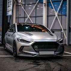 a silver car parked in front of a building