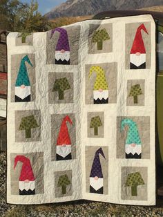 an image of a quilt with gnomes on it