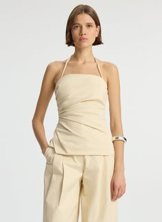 front  view of woman wearing beige halter top with side ruching and beige wide leg pant Pleated Top Outfit, Pleats Top, Evening Jumpsuit, Womens Halter Tops, Suiting Fabric, Top Halter, Beige Top, Halter Tops, Fall Fashion Outfits