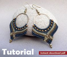 a pair of beaded earrings sitting on top of a rock