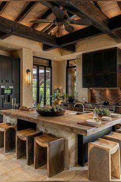 a large kitchen with an island and lots of stools in the middle of it