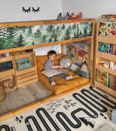 a young boy sitting on top of a bunk bed in a room filled with books