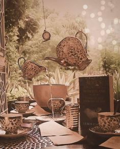 a table topped with lots of cups and saucers