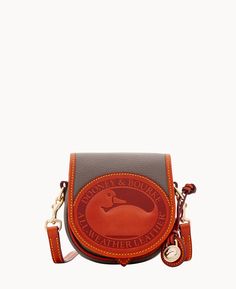 Retro Revamp    A Dooney & Bourke original, the All-Weather Leather Duck Bag is finished with our signature pebbled leather flap and heritage duck logo for an unmistakable retro feel. Inspired by our archives, this small leather crossbody bag offers ample storage with both inside and outside pockets. Best of all? This leather is known for its long-wearing durability. Dooney And Burke, Duck Logo, Duck Bag, Key Hook, Classic Handbags, Satchel Tote, Dooney And Bourke, Dooney Bourke Handbags, Dooney & Bourke