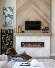 a living room with a fireplace, chair and television on the wall next to it