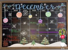 a chalk board with christmas decorations on it