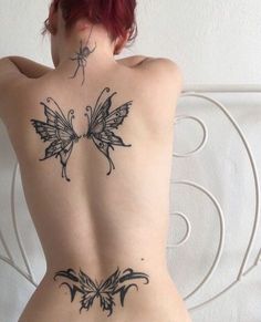 the back of a woman's body with butterfly tattoos on her lower and upper ribs