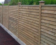 a wooden fence in front of a house