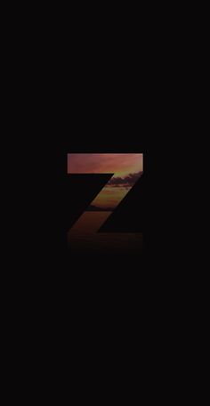 the letter z is shown in front of an orange and black sky with clouds at sunset