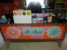 an office desk with flowers on it and the name mrs ruth