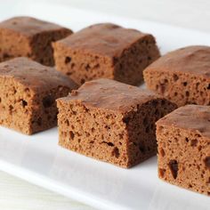 several pieces of brownie on a white plate