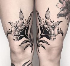 the legs are decorated with black and white flowers on each side of their thighs, while one leg is covered in tattoos