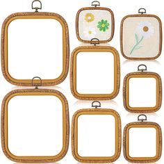 six wooden frames with flowers on them and one has a white flower in the middle