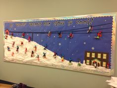 a bulletin board is decorated with snowmen and skis in the background, while people are skiing down a hill