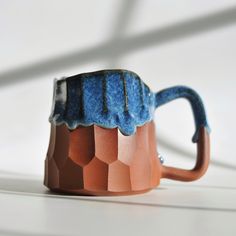 a blue and brown mug sitting on top of a table