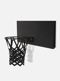 a basketball hoop mounted to the side of a wall with an object hanging on it