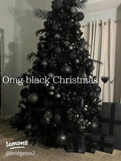 a black christmas tree is decorated with ornaments