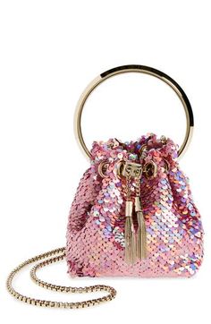 The label's iconic pouch is reinterpreted in an ultracompact silhouette with this iridescently sequined bag boasting an oversized ring handle and metal tassels. Drawstring closure Top carry handle; pull-through chain strap Satin lining Textile/crystal Made in Italy Designer Handbags Gold Sequin Fabric, Luxury Belts, Bon Bon, Roger Vivier, Velvet Bow, Engraved Logo, Shopping Tote, Pink Bag, Manolo Blahnik