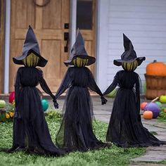 three children dressed in halloween costumes holding hands