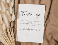 there is a card with the words freshen up on it next to some dry grass