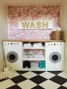 a white and black checkered floor in a doll's house with a wash sign on the wall