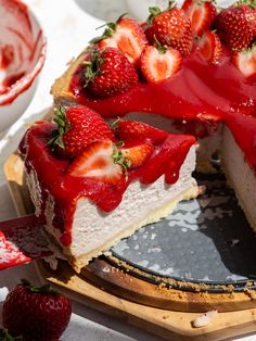 a cheesecake with strawberries is on a plate