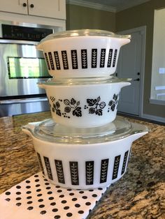 three dishes stacked on top of each other in the middle of a kitchen countertop