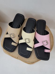 Editor's NotesKERRIJADE's uniquely designed buckle accent slide/sandals are comfortable and stylish. - Open square toe- Sponge midsole- Buckle detail on the vamp- Toe-ring- Vamp holds most of your instep for comfort - Wide cushioned outsoleMeasurements(in.)- Size: KR 225 MM - KR 255 MM- Heel height: 1.18 in- Fits true to size. Composition & Care- Upper: Lambskin - Lining: Pigskin- Avoid direct heat and moisture- Do not wash- Avoid fire- Dry with a dry cloth when wet- Avoi Flat Sandals With Tang Buckle, Trendy Flat Heel Mules With Buckle Closure, Beige Flat Mules With Buckle Closure, Beach Slides With Tang Buckle, Summer Footbed Sandals With Tang Buckle And Flat Heel, Chic Slides With Buckle Closure And Flat Heel, Trendy Flat Heel Slides With Buckle Closure, Trendy Slides With Buckle Closure, Beige Open Toe Sandals With Tang Buckle