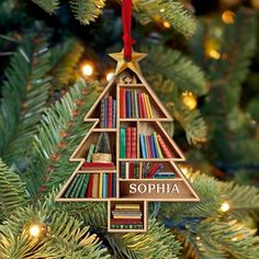 a christmas tree ornament with books on it and the name sophiia