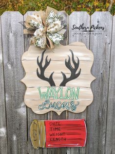 a wooden sign with deer antlers on it