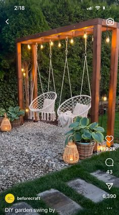 an outdoor swing chair with lights hanging from it's sides and some potted plants on the other side