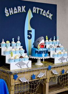 a shark themed birthday party with cupcakes and cakes