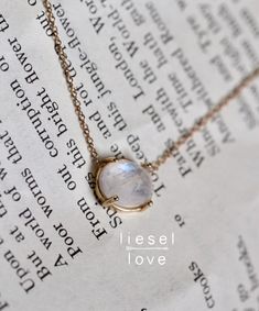 "Rainbow moonstone is known to provide psychic protection, acting as a prism by diffusing energy through the aura. Give our \"Prism\" necklace as a token of protection to your loved ones or even to yourself! Also makes a stunning addition to a wedding outfit! - Rose cut Rainbow Moonstone measures 8 x 10mm - Moonstone gives off hints of blue and purple in the light - Natural inclusions give a different texture to each stone, making each necklace one of a kind! - Choose your length: 14\" - 15\" - Moonstone Crystal Necklace With Moon Phase, Oval Moon Phase Necklace As A Gift, Mystical Oval Gemstone Necklace, Moon Phase Oval Necklace For Gifts, Oval Moon Phase Necklace For Gift, Oval Moon Phase Necklace Gift, Spiritual Oval Moonstone Necklace, Healing Moonstone Crystal Necklace, Round Moonstone Gemstone Crystal Necklaces